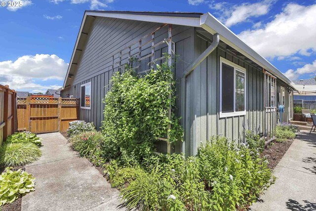 5986 Rombauer Rd, Eugene, OR 97402 - view of home's exterior with board and batten siding and a gate