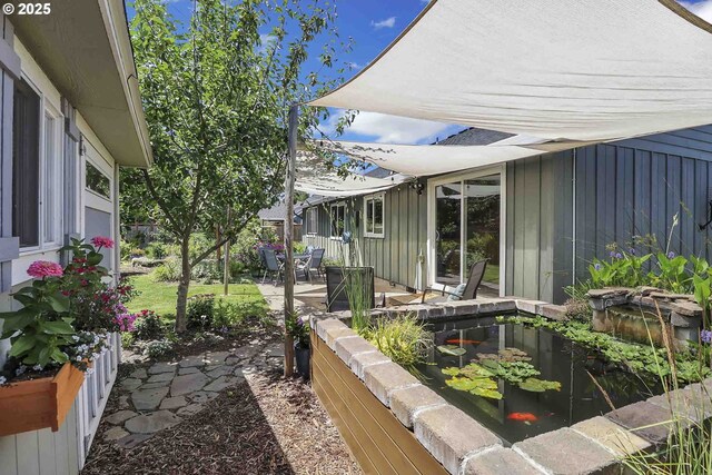 5986 Rombauer Rd, Eugene, OR 97402 - view of patio featuring a small pond