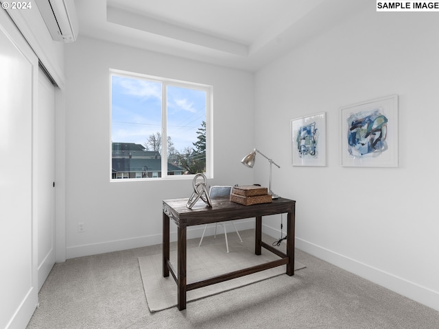 office featuring carpet floors, a tray ceiling, an AC wall unit, and baseboards