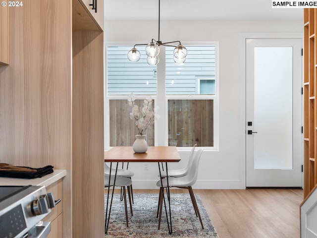 dining room featuring light wood-style floors and a notable chandelier