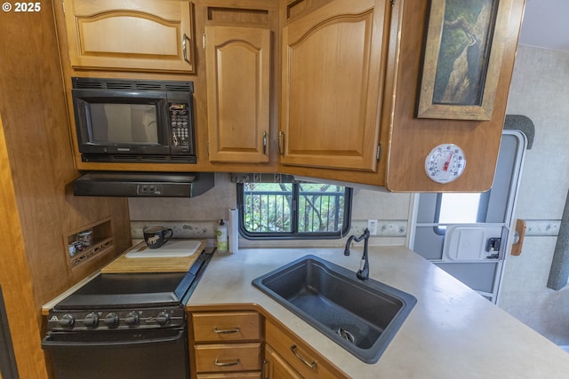 24706 NE Columbia Tie Rd Unit 41/21, Amboy, WA 98601 - kitchen featuring brown cabinetry, black appliances, a sink, and light countertops