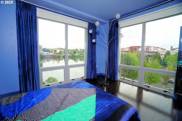 1260 NW Naito Pkwy Unit 604B, Portland, OR 97209 - bedroom featuring a water view and wood finished floors