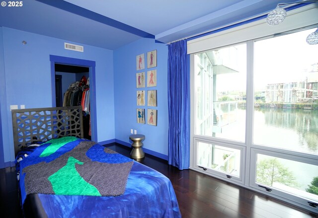 1260 NW Naito Pkwy Unit 604B, Portland, OR 97209 - bedroom featuring visible vents, a water view, wood finished floors, and multiple windows