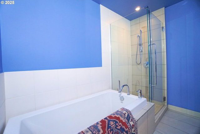 1260 NW Naito Pkwy Unit 604B, Portland, OR 97209 - bathroom featuring tile patterned flooring, a bath, a stall shower, and recessed lighting