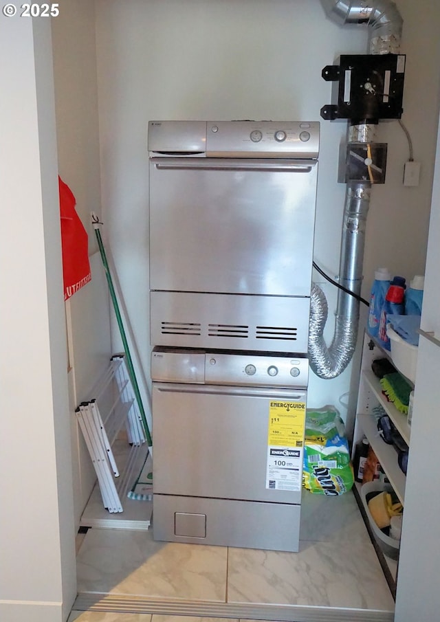 1260 NW Naito Pkwy Unit 604B, Portland, OR 97209 - laundry area with stacked washer / drying machine and laundry area