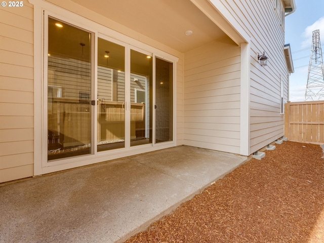 property entrance with a patio area and fence