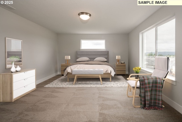 bedroom with multiple windows, light carpet, and baseboards