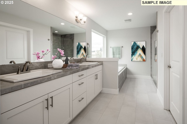 bathroom with double vanity, a stall shower, and a sink