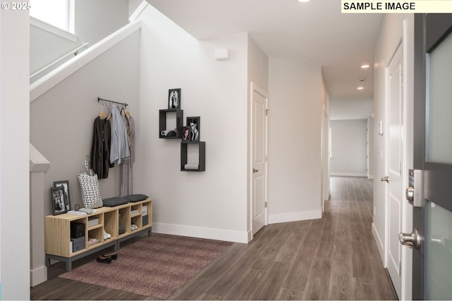 hall featuring recessed lighting, wood finished floors, and baseboards