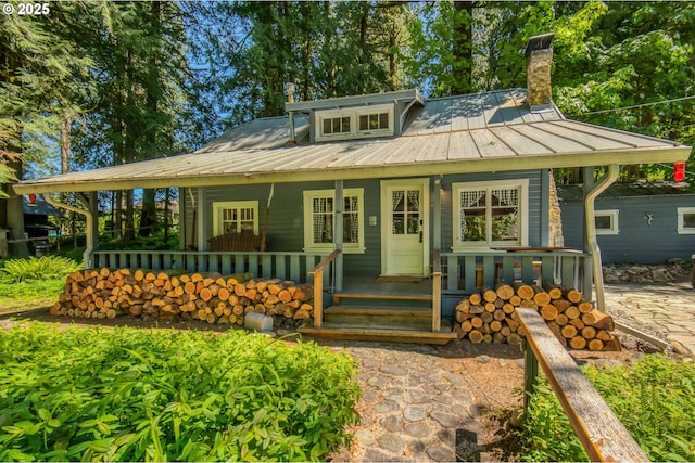 26630 E Roberts Rd, Welches, OR 97067 - view of front of property featuring covered porch, metal roof, and a chimney