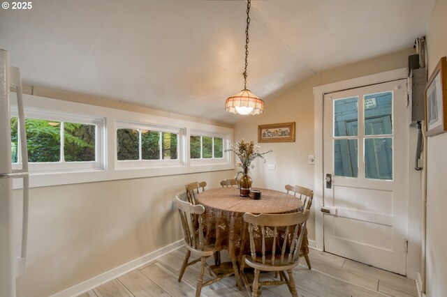 26630 E Roberts Rd, Welches, OR 97067 - dining area with light wood-style flooring, lofted ceiling, plenty of natural light, and baseboards