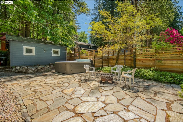 26630 E Roberts Rd, Welches, OR 97067 - fenced backyard featuring a hot tub, a patio area, an outdoor fire pit, and an outdoor structure