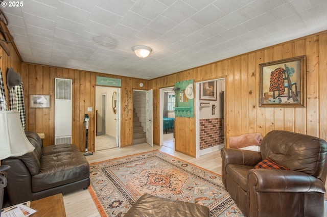26630 E Roberts Rd, Welches, OR 97067 - living area with a heating unit, light wood-style floors, and wood walls