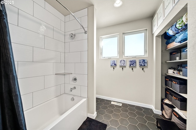 bathroom featuring tile patterned flooring and shower / tub combo with curtain