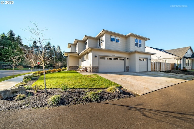 view of front of property featuring a front yard and a garage