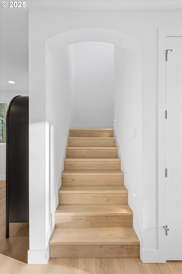 staircase featuring wood-type flooring