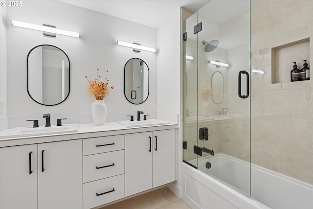 bathroom with tile patterned flooring, vanity, and combined bath / shower with glass door