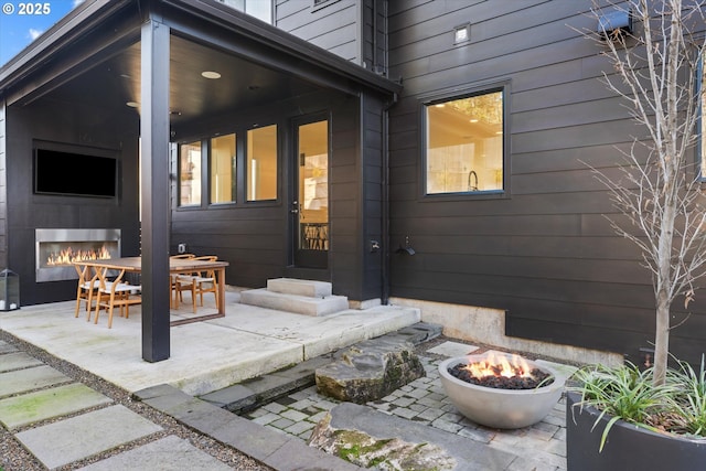 back of house with a patio and an outdoor fire pit