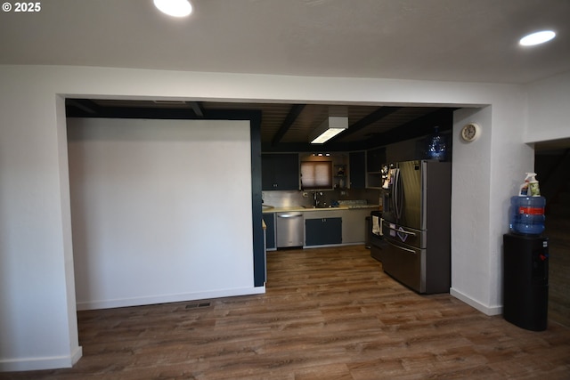 kitchen featuring baseboards, appliances with stainless steel finishes, dark wood-style flooring, light countertops, and recessed lighting