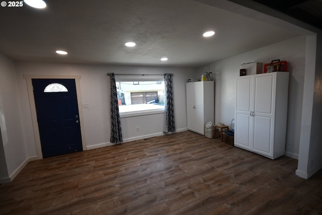 foyer entrance with baseboards, dark wood finished floors, and recessed lighting