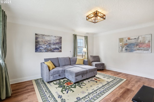 545 N St, Castle Rock, WA 98611 - living area featuring wood finished floors, baseboards, and a textured ceiling