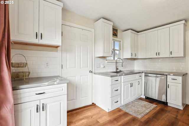 545 N St, Castle Rock, WA 98611 - kitchen featuring stainless steel counters, stainless steel dishwasher, a sink, backsplash, and white cabinetry