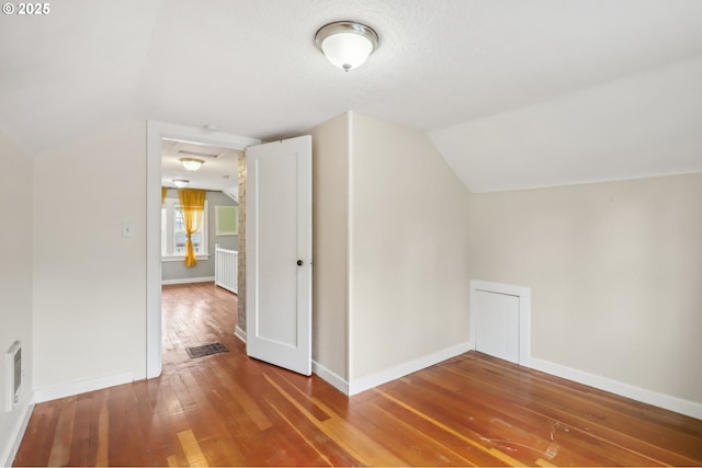 545 N St, Castle Rock, WA 98611 - additional living space featuring vaulted ceiling, wood-type flooring, and baseboards
