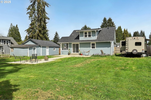 545 N St, Castle Rock, WA 98611 - rear view of property featuring a patio, a lawn, entry steps, an outbuilding, and a shingled roof