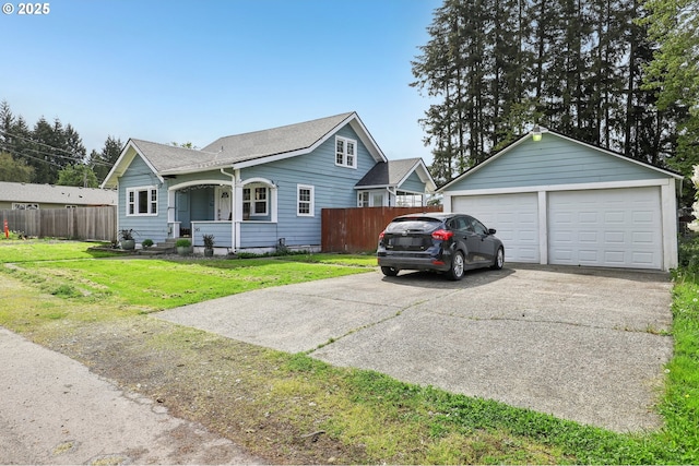 545 N St, Castle Rock, WA 98611 - view of front of house with a garage, a shingled roof, an outbuilding, and a porch