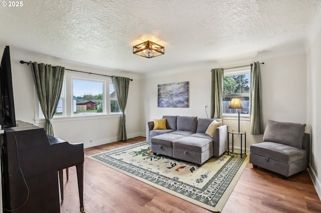 545 N St, Castle Rock, WA 98611 - living area with wood finished floors, a textured ceiling, and baseboards