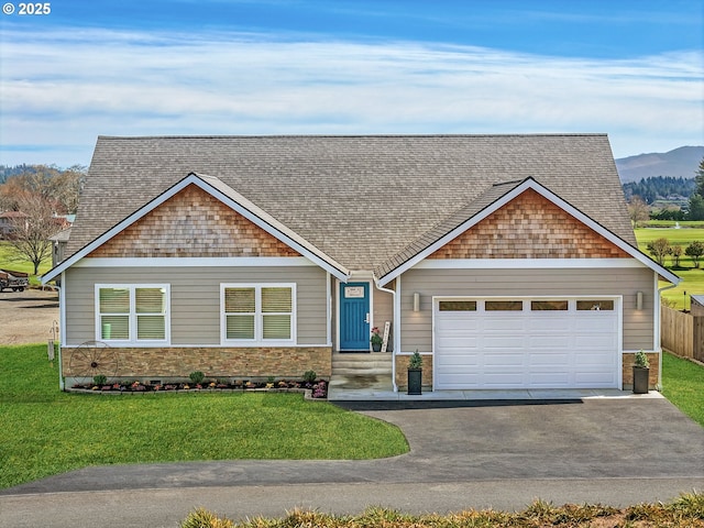 35692 Bella Ridge Loop, Astoria, OR 97103 - craftsman-style house featuring aphalt driveway, a garage, a front yard, roof with shingles, and a mountain view
