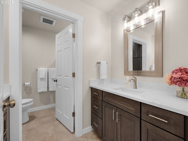 35692 Bella Ridge Loop, Astoria, OR 97103 - bathroom with visible vents, baseboards, toilet, vanity, and tile patterned flooring