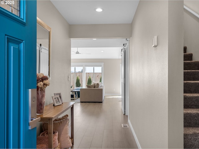 35692 Bella Ridge Loop, Astoria, OR 97103 - corridor with baseboards, stairs, wood finished floors, and recessed lighting