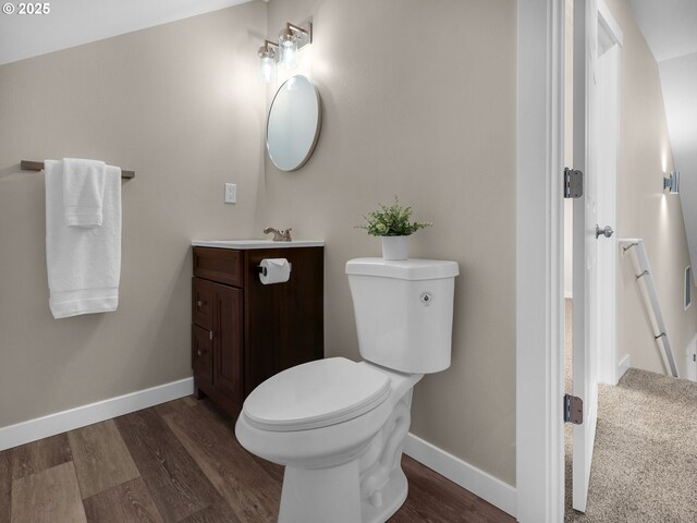 35692 Bella Ridge Loop, Astoria, OR 97103 - bathroom featuring toilet, wood finished floors, baseboards, and vanity