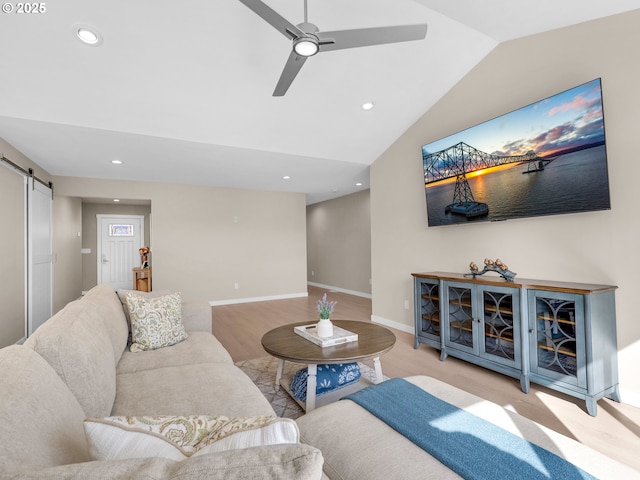 35692 Bella Ridge Loop, Astoria, OR 97103 - living area with vaulted ceiling, baseboards, a barn door, ceiling fan, and wood finished floors