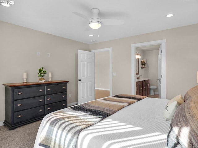 35692 Bella Ridge Loop, Astoria, OR 97103 - bedroom with a ceiling fan, light carpet, ensuite bath, baseboards, and recessed lighting