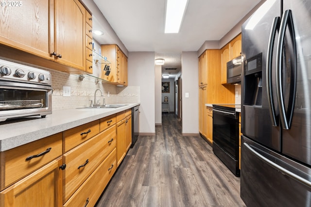 8312 SW Tygh Loop, Tualatin, OR 97062 - kitchen featuring stainless steel fridge with ice dispenser, stove, black microwave, a sink, and dark wood-type flooring