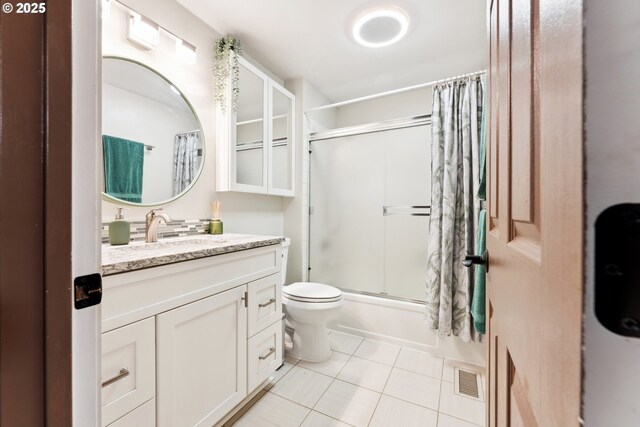 8312 SW Tygh Loop, Tualatin, OR 97062 - full bath with tile patterned flooring, vanity, toilet, and combined bath / shower with glass door