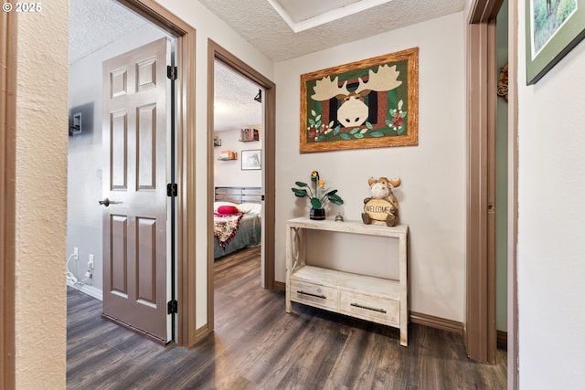 8312 SW Tygh Loop, Tualatin, OR 97062 - hall with a textured ceiling, dark wood-style flooring, and baseboards