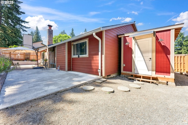 8312 SW Tygh Loop, Tualatin, OR 97062 - back of house featuring a patio area and a chimney
