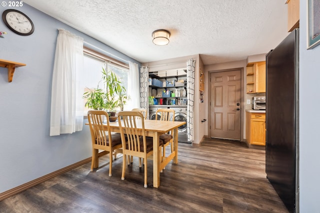8312 SW Tygh Loop, Tualatin, OR 97062 - dining space with washing machine and dryer, dark wood-style floors, baseboards, and a textured ceiling