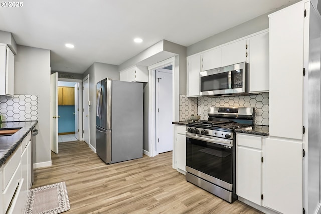 284 N 17th St, Saint Helens, OR 97051 - kitchen featuring stainless steel appliances, light wood-style floors, white cabinets, recessed lighting, and decorative backsplash