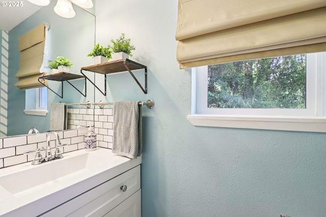284 N 17th St, Saint Helens, OR 97051 - bathroom featuring decorative backsplash, vanity, and a textured wall