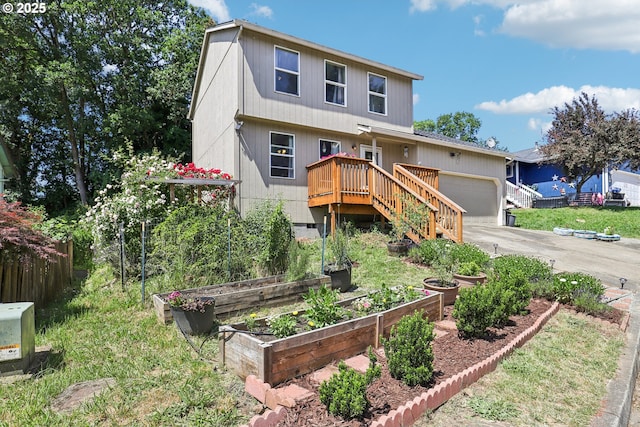 284 N 17th St, Saint Helens, OR 97051 - view of front facade with a garden, an attached garage, concrete driveway, and a deck
