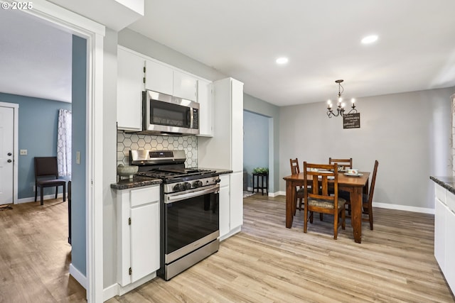 284 N 17th St, Saint Helens, OR 97051 - kitchen with appliances with stainless steel finishes, light wood-style flooring, tasteful backsplash, white cabinets, and recessed lighting