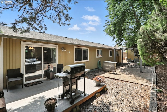 1481 SW 5th Pl, Gresham, OR 97080 - rear view of property featuring a wooden deck, roof with shingles, and a patio area
