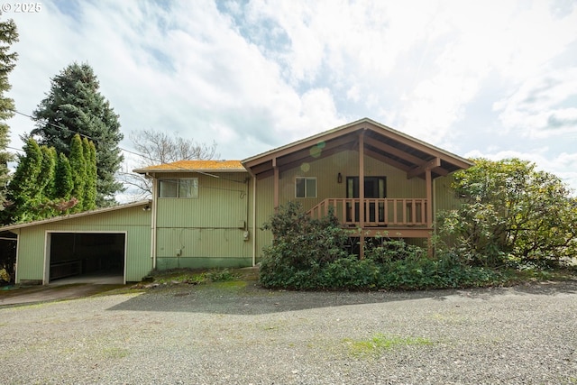 view of side of home featuring driveway and a garage