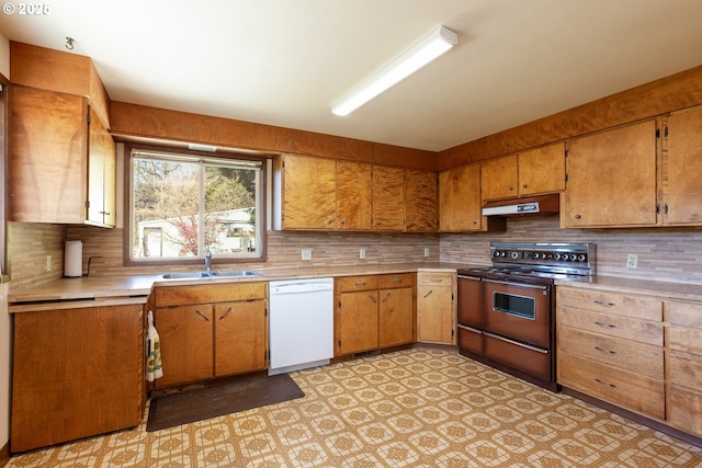 kitchen featuring a sink, dishwasher, light countertops, electric range, and under cabinet range hood