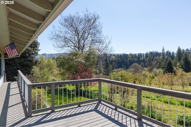 balcony featuring a view of trees