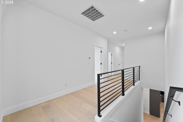 stairway featuring visible vents, recessed lighting, baseboards, and wood finished floors